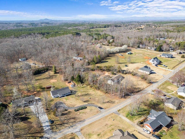 birds eye view of property featuring a wooded view