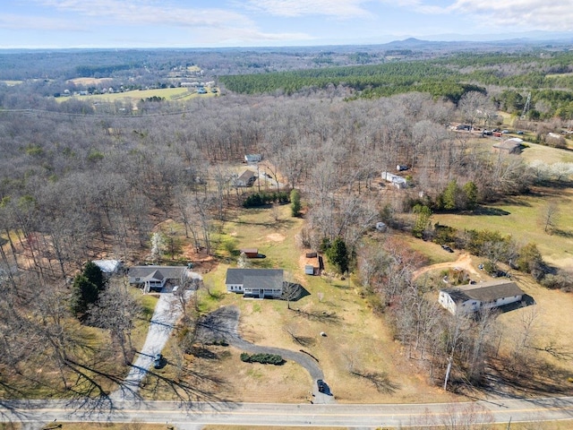 aerial view featuring a wooded view