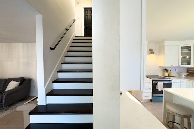 stairway featuring wood finished floors