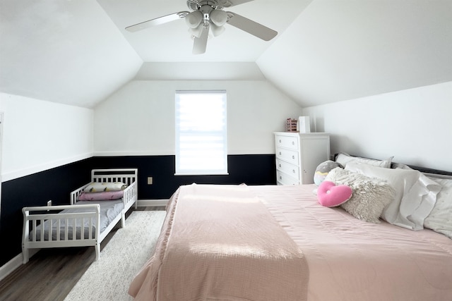 bedroom featuring baseboards, wood finished floors, a ceiling fan, and vaulted ceiling