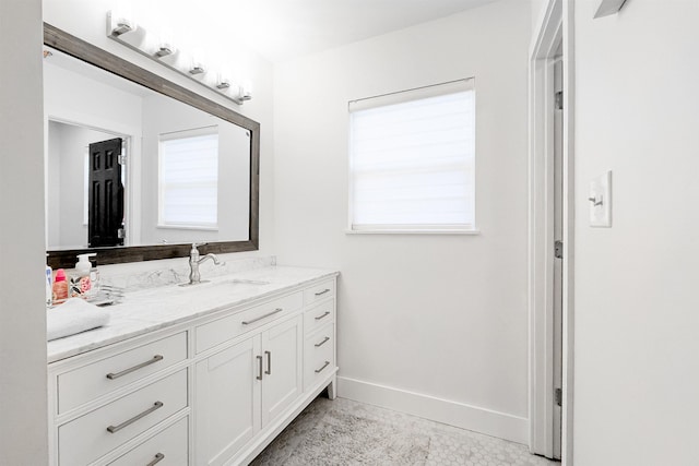 bathroom featuring vanity and baseboards