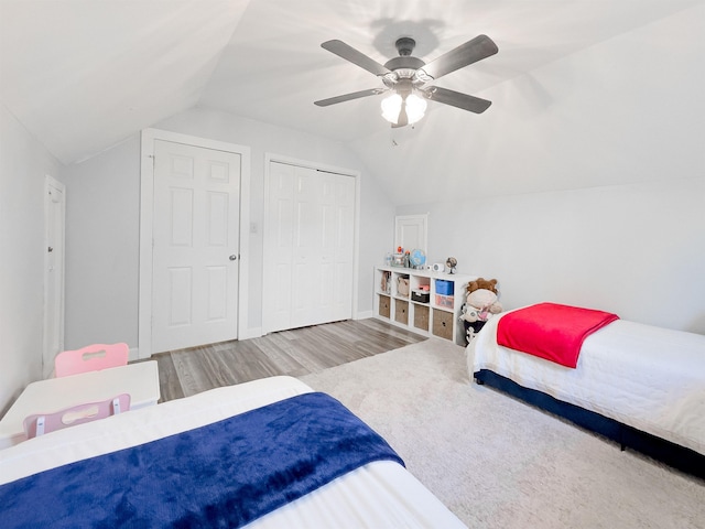 bedroom featuring a closet, vaulted ceiling, a ceiling fan, and wood finished floors