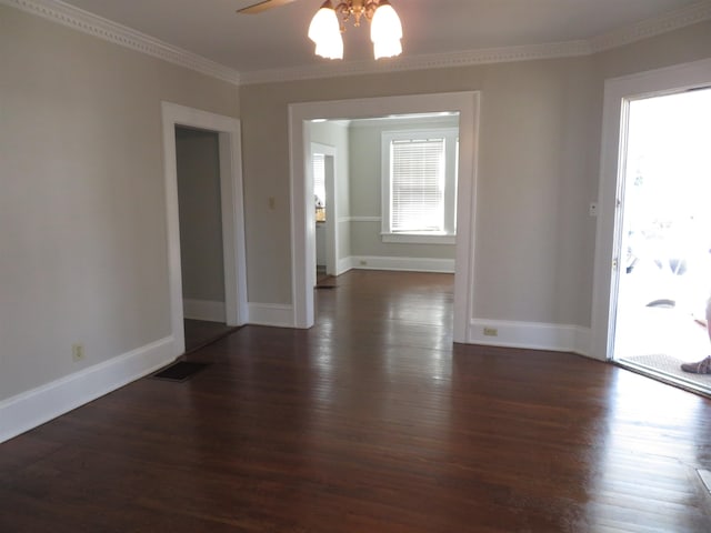 spare room featuring ornamental molding, dark wood-style floors, baseboards, and ceiling fan