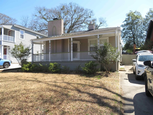 view of front of property with a porch and a chimney