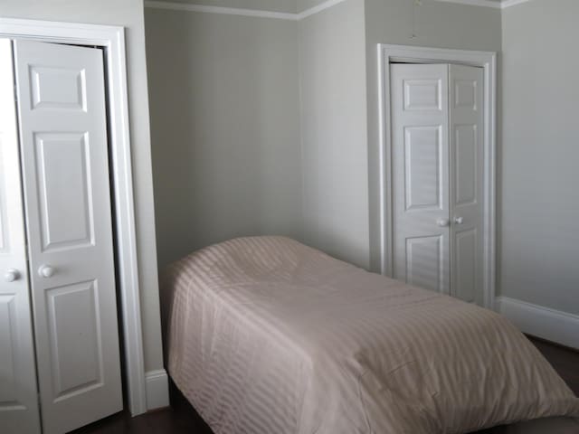 bedroom featuring baseboards and crown molding