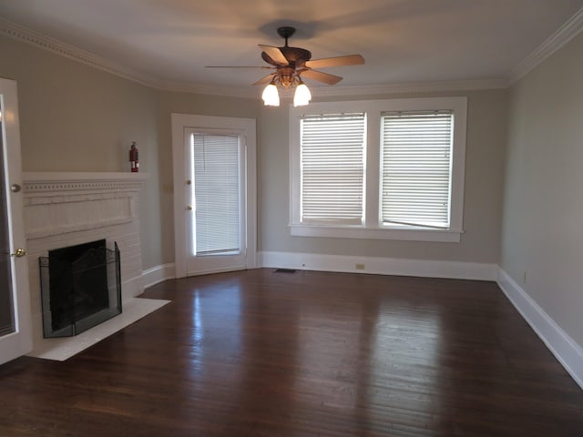 unfurnished living room with visible vents, a brick fireplace, dark wood-type flooring, crown molding, and a ceiling fan