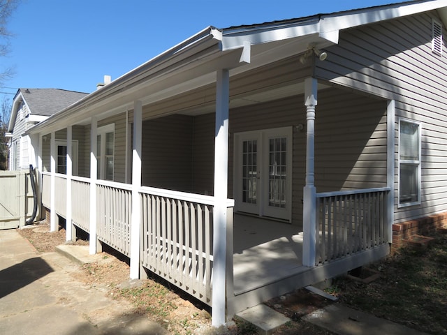 view of property exterior featuring french doors and covered porch