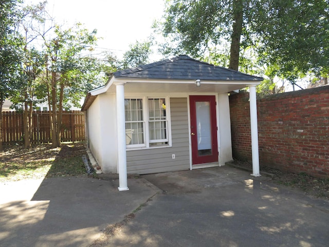 view of outbuilding with an outdoor structure and fence