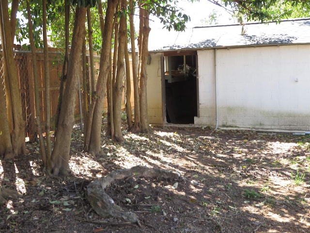 view of outbuilding featuring an outdoor structure and fence