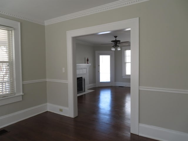 unfurnished living room featuring visible vents, a fireplace, a ceiling fan, and wood finished floors