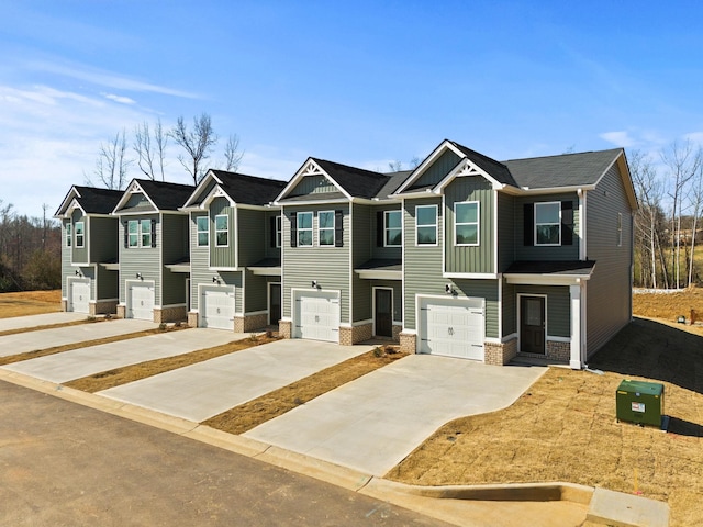 view of front of property featuring board and batten siding, concrete driveway, and an attached garage