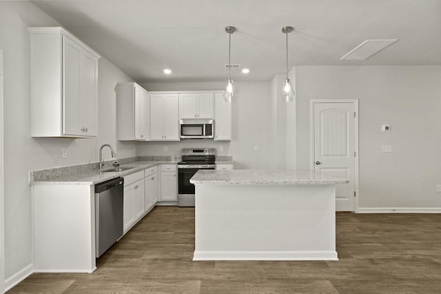 kitchen with a sink, stainless steel appliances, dark wood-style floors, and white cabinetry