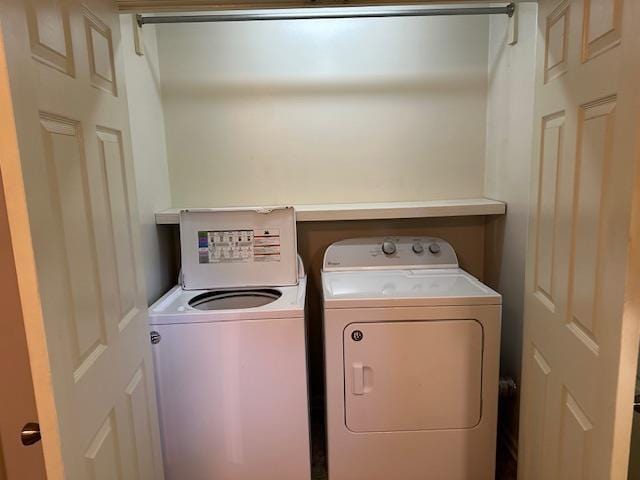 clothes washing area featuring laundry area and washing machine and clothes dryer