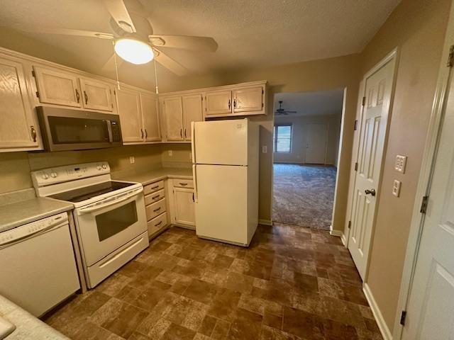 kitchen with white appliances, light countertops, and ceiling fan