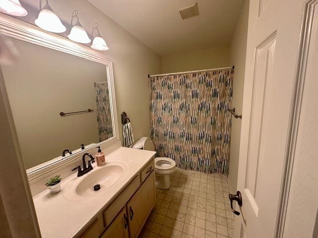 bathroom featuring visible vents, toilet, vanity, and a shower with shower curtain