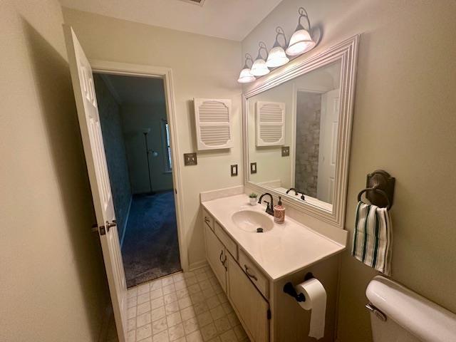 bathroom with toilet and vanity