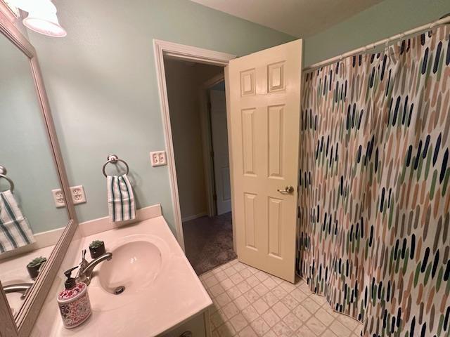 bathroom with vanity and a shower with shower curtain