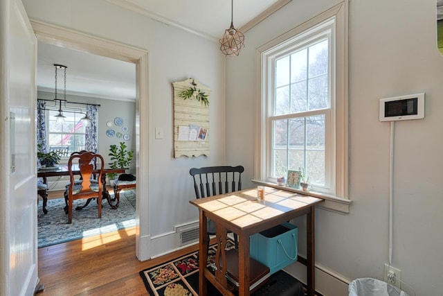 dining area featuring crown molding and wood finished floors