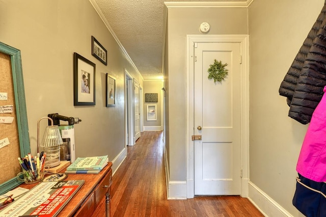 hall with crown molding, dark wood-style floors, baseboards, and a textured ceiling