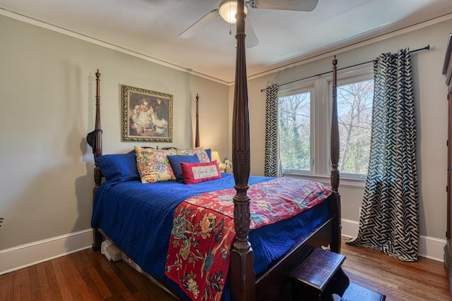 bedroom with a ceiling fan, wood finished floors, and baseboards