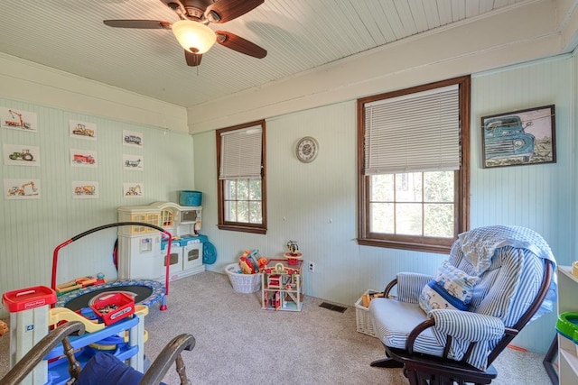 rec room featuring carpet flooring, visible vents, and ceiling fan