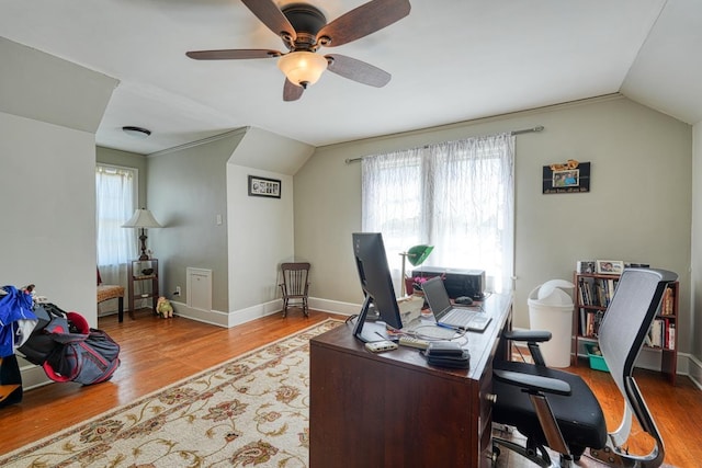 home office with a wealth of natural light, lofted ceiling, wood finished floors, and a ceiling fan