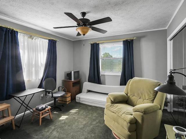 sitting room with carpet floors, a textured ceiling, ornamental molding, and a ceiling fan