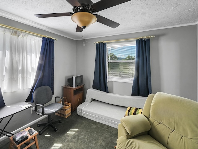 sitting room with carpet flooring, a textured ceiling, ceiling fan, and ornamental molding