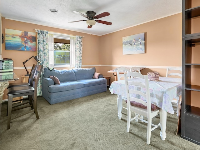 carpeted living room with visible vents, a textured ceiling, crown molding, and ceiling fan