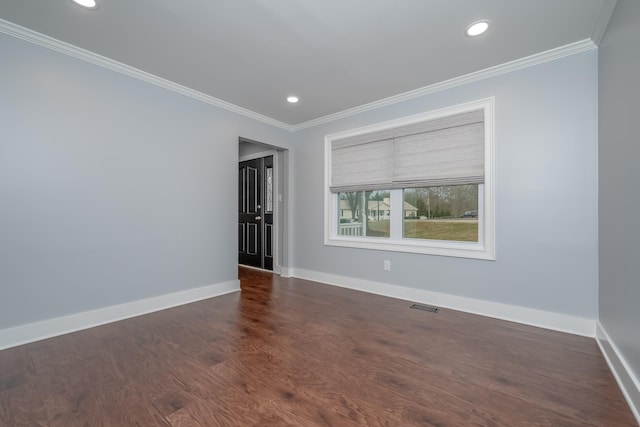 unfurnished room featuring baseboards, visible vents, and ornamental molding