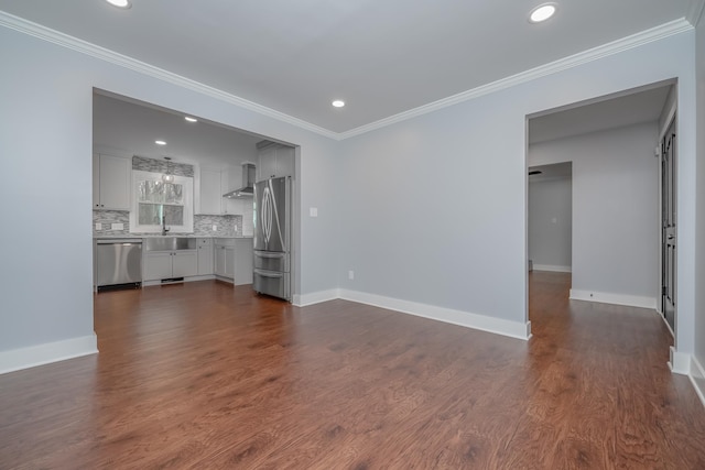 unfurnished living room featuring baseboards, dark wood finished floors, and crown molding