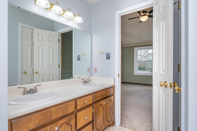 bathroom with ceiling fan, double vanity, and a sink