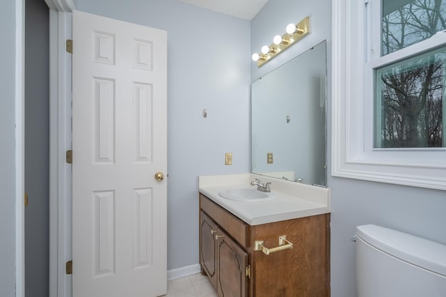 half bath featuring vanity and toilet