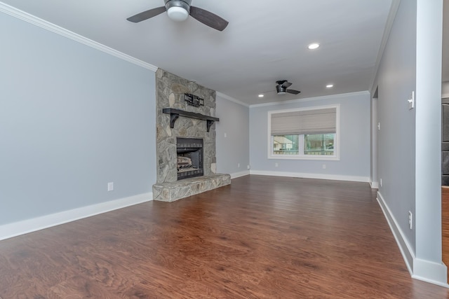 unfurnished living room featuring dark wood-style floors, baseboards, a fireplace, ceiling fan, and crown molding