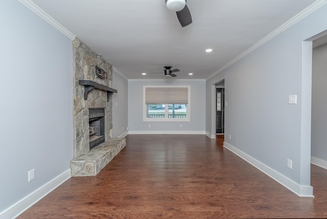 unfurnished living room with baseboards, ornamental molding, a fireplace, dark wood-style floors, and a ceiling fan