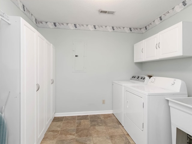 clothes washing area featuring visible vents, electric panel, cabinet space, a sink, and washing machine and dryer