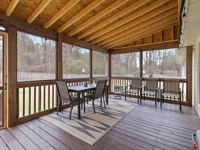 sunroom featuring lofted ceiling