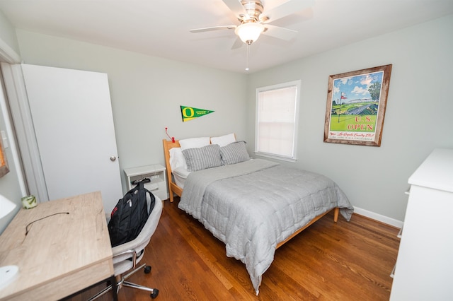 bedroom featuring ceiling fan, baseboards, and wood finished floors