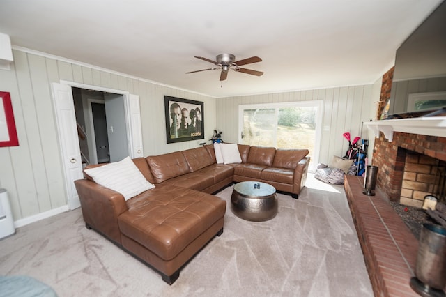 carpeted living area featuring a brick fireplace, baseboards, a ceiling fan, and ornamental molding