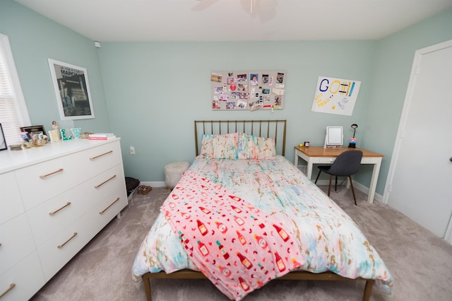 carpeted bedroom featuring baseboards and ceiling fan