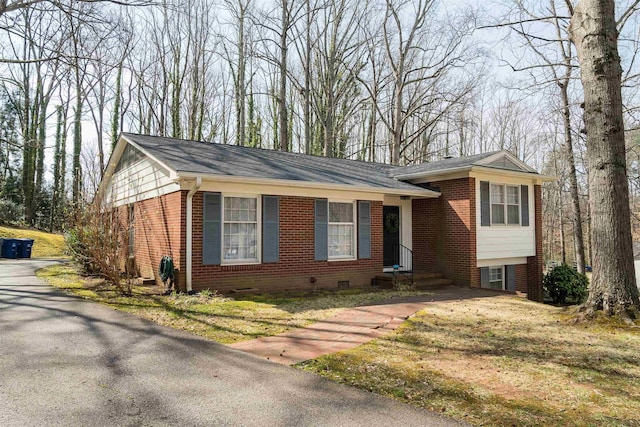 tri-level home featuring brick siding