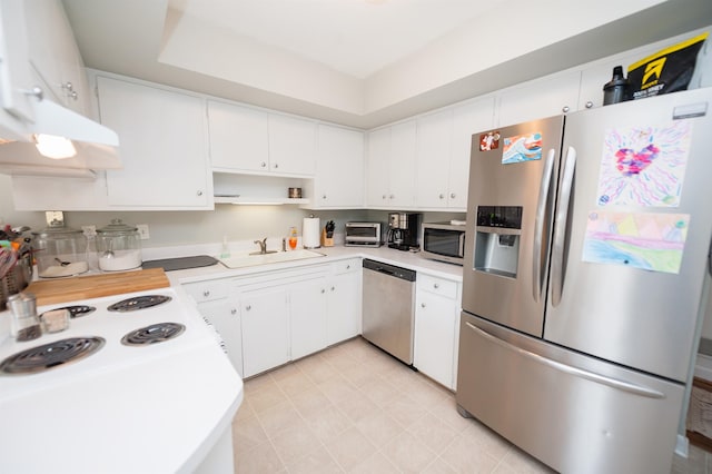 kitchen with a sink, stainless steel appliances, a toaster, and light countertops