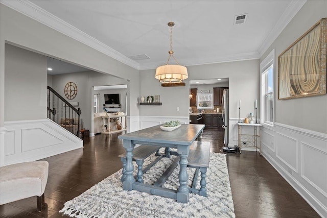 dining space with visible vents, ornamental molding, stairs, and dark wood-style flooring