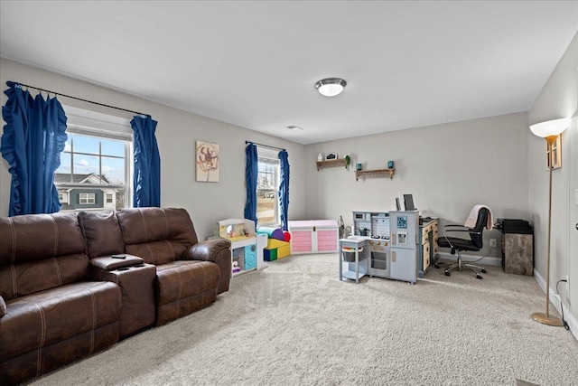 living area featuring plenty of natural light, baseboards, and carpet floors