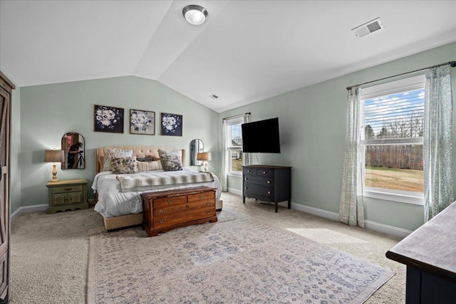 bedroom featuring vaulted ceiling, multiple windows, baseboards, and visible vents