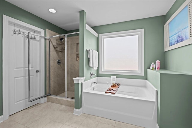 full bathroom featuring a bath, tile patterned flooring, and a stall shower