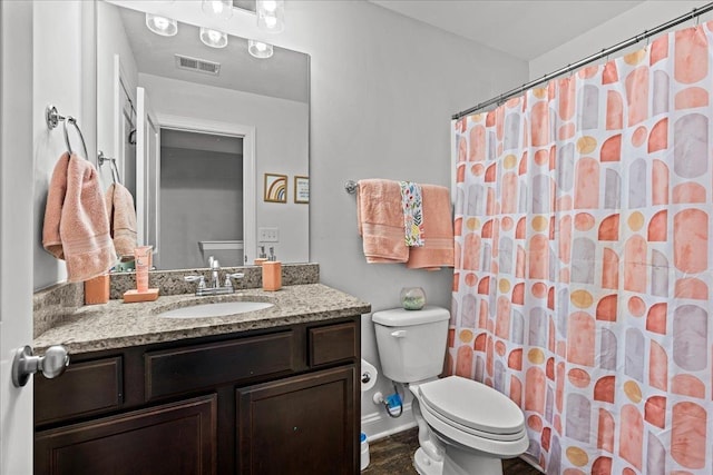 full bathroom with visible vents, toilet, wood finished floors, baseboards, and vanity