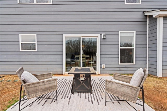 wooden deck with an outdoor fire pit