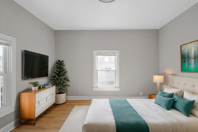 bedroom featuring baseboards and light wood-style floors