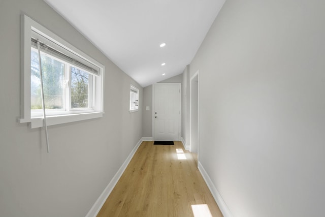 hall with recessed lighting, baseboards, lofted ceiling, and light wood finished floors